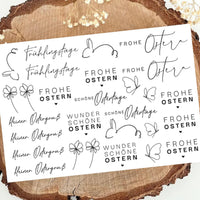 Schwarz weißes Design mit Oster-Motiven: Schriftzüge 'Frohe Ostern', Hasen und Blumen, auf einem natürlichen Untergrund. Ideal für kreative Projekte. RUB ON UV Sticker randlos von easy-sticks.