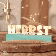 Herbst Dekoration von easy-sticks mit dem Titel 'Herbst - Zauber, Zeit, Liebe'. Die Produktpräsentation zeigt stilvolle Schriftzüge in Gold auf einer blauen Basis, umgeben von dekorativen Elementen. Perfekt für kreative Bastelprojekte.