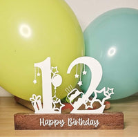 Heller Geburtstags Aufsteller mit den Zahlen 12 und 'Happy Birthday' von easy-sticks, umgeben von bunten Luftballons.