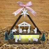 Kreative Silikon Weihnachtskrippe von easy-sticks, dekoriertes Arrangement mit Holzstruktur und Lichter, festliche Weihnachtsstimmung.