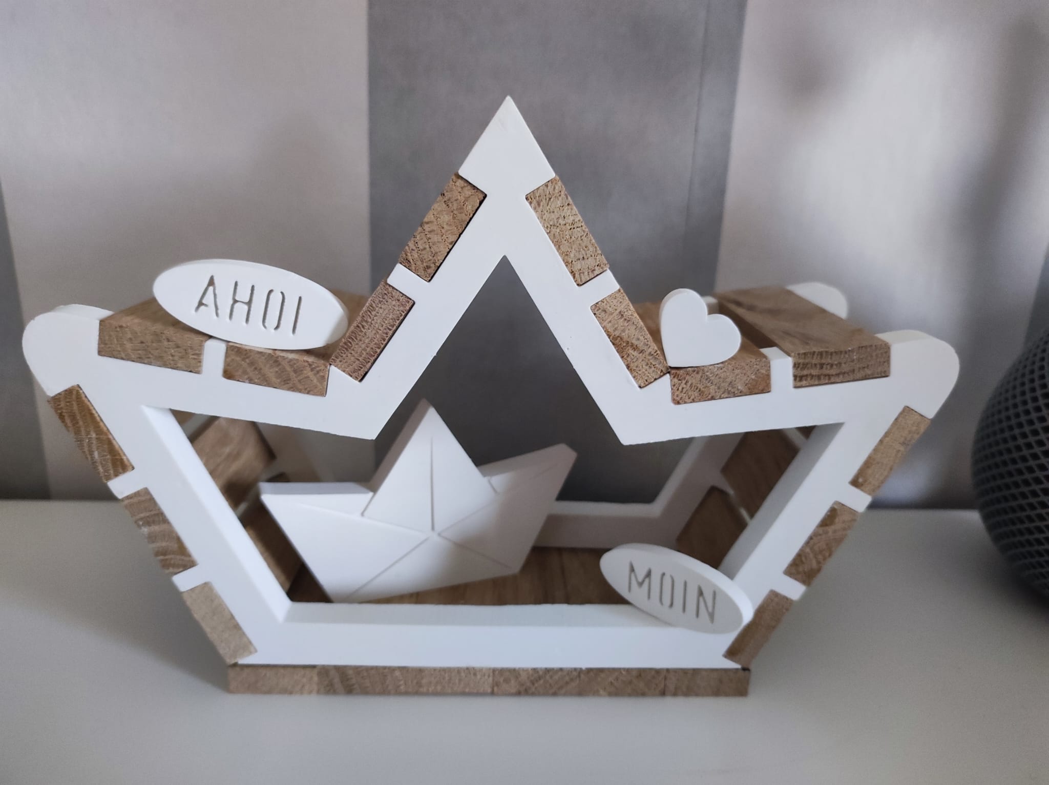 Fertiges Dekorationsobjekt mit der Easy-Sticks 5-in-1 Gießform - Schiffchen, bestehend aus einem stilvollen weißen Bootsrahmen, verziert mit Holz-Elementen und den Schriftzügen "Ahoi" und "Moin".
