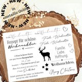 Weiße Weihnachtsaufkleber Rub On UV Sticker Randlos A5 von easy-sticks, verz decorated mit festlichen Texten und einem Rentier, abgebildet auf schönem Holzuntergrund.