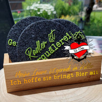 Kreatives Set von Bieruntersetzern mit humorvollem Aufdruck, präsentiert in einem Holzhalter. Ideal für gesellige Abende, entworfen von easy-sticks mit der Bier Sprüche Laserdatei.
