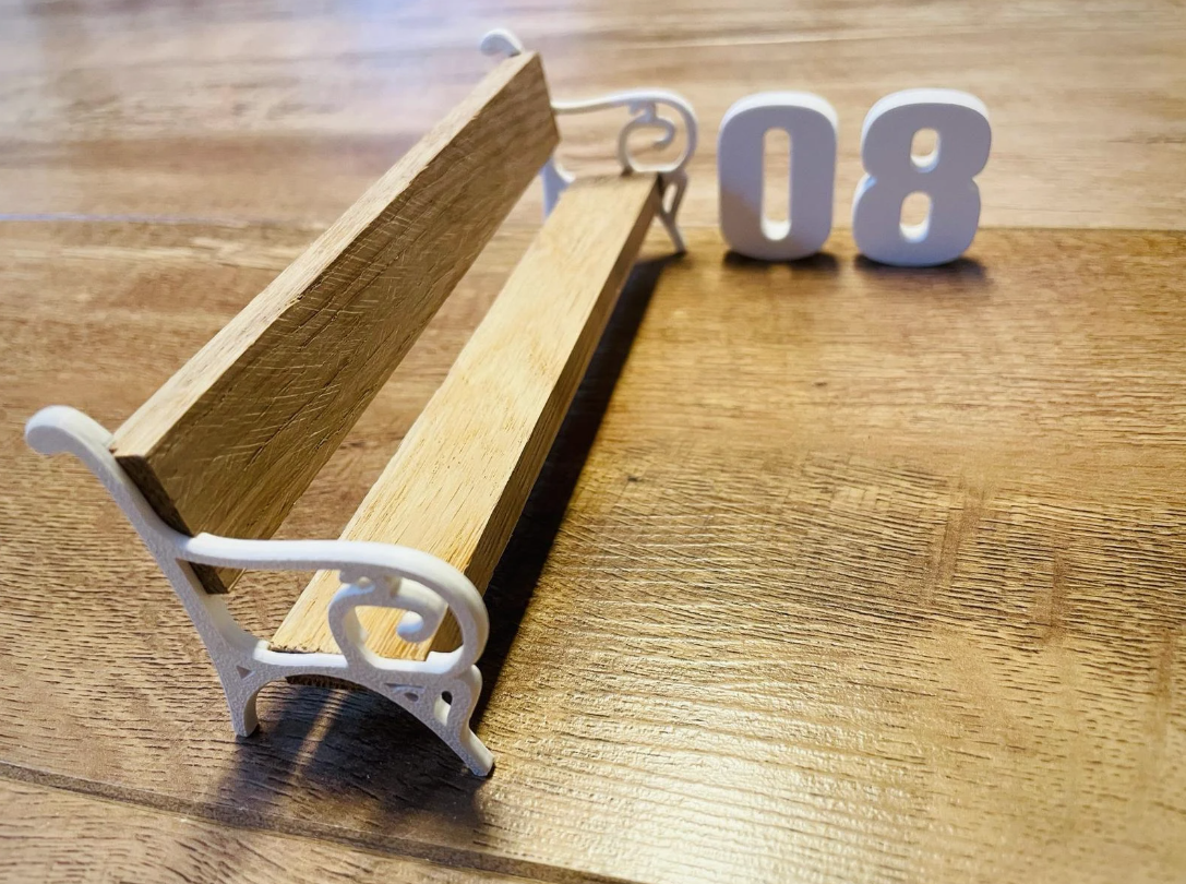 Schöne Darstellung einer kleinen Bank, gefertigt mit Bank Edge Design 08 von easy-sticks, inklusive der filigranen Seitenteile und Holzsitzfläche.