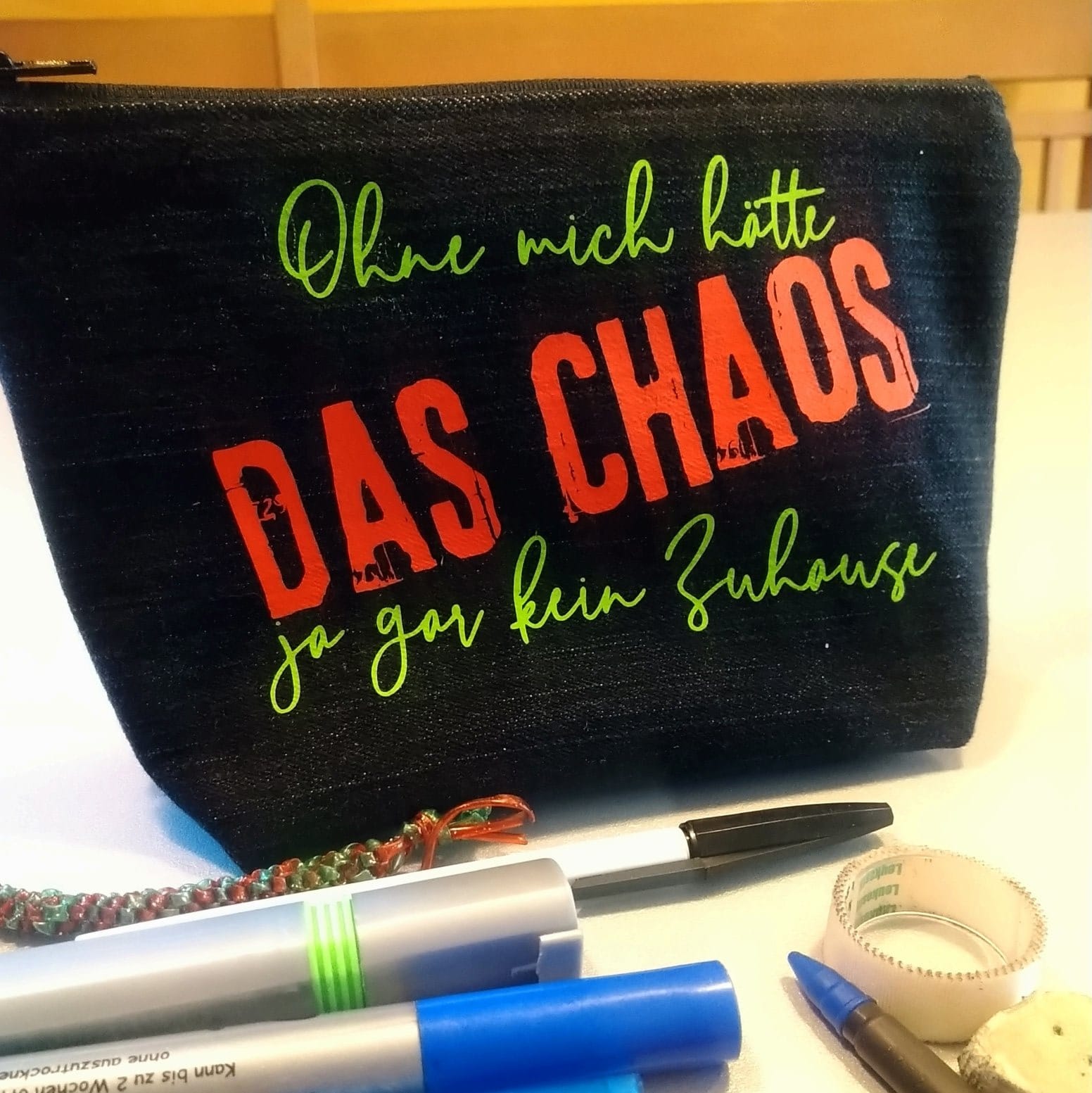 Stiftetasche mit dem Aufdruck 'DAS CHAOS', designt von easy-sticks, eine perfekte Ergänzung für kreative Menschen.