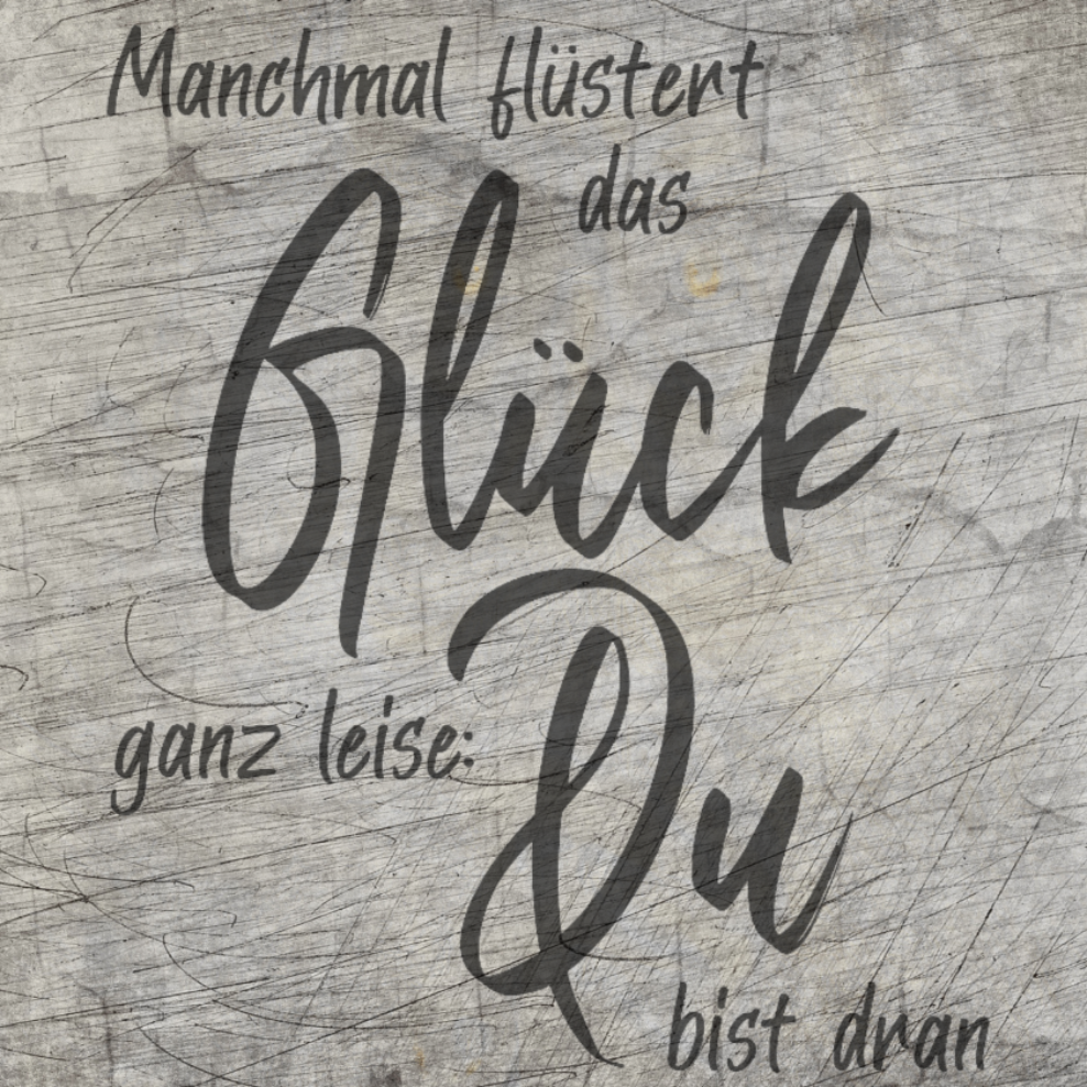 Künstlerische Darstellung der Plotterdatei "Manchmal flüstert das Glück ganz leise: Du bist dran" von easy-sticks, die die Worte auf einer holzähnlichen Textur in elegantem Schwarz zeigt. Perfekt für kreative DIY-Projekte.