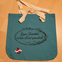 Stylische Tragetasche mit der Aufschrift 'Gegen Dummheit ist kein Kraut gewachsen' von easy-sticks. Die Tasche in Türkis verleiht kreativen DIY-Projekten einen individuellen Touch.