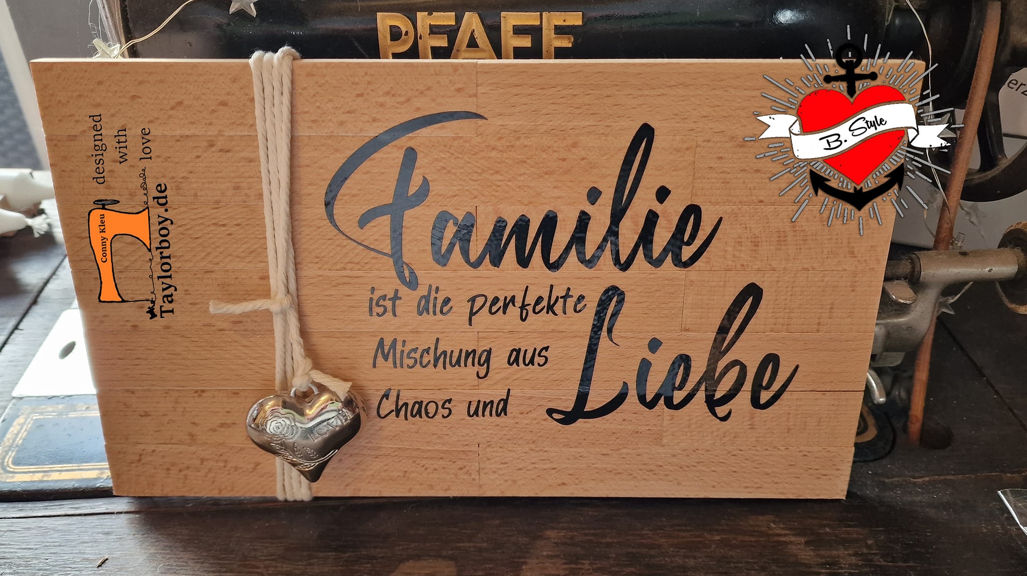 Holzschild mit der Aufschrift "Familie ist die perfekte Mischung aus Liebe und Chaos" von easy-sticks, dekoriert mit einer Herzanhänger und einem rustikalen Design.