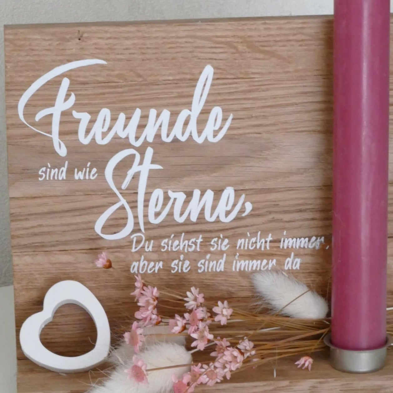 Hochwertige Holzplatte mit dem Schriftzug "Freunde sind wie Sterne, Du siehst sie nicht immer, aber sie sind immer da". Dekorative Kerze und florale Akzente bilden einen stilvollen Tischschmuck. Perfekt für kreative DIY-Projekte mit der Plotterdatei von easy-sticks.