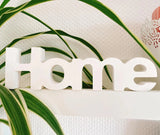 Silikonform von Easy-Sticks zeigt den eleganten Schriftzug 'Home' umgeben von Pflanzen, perfekt für eine stilvolle Inneneinrichtung.