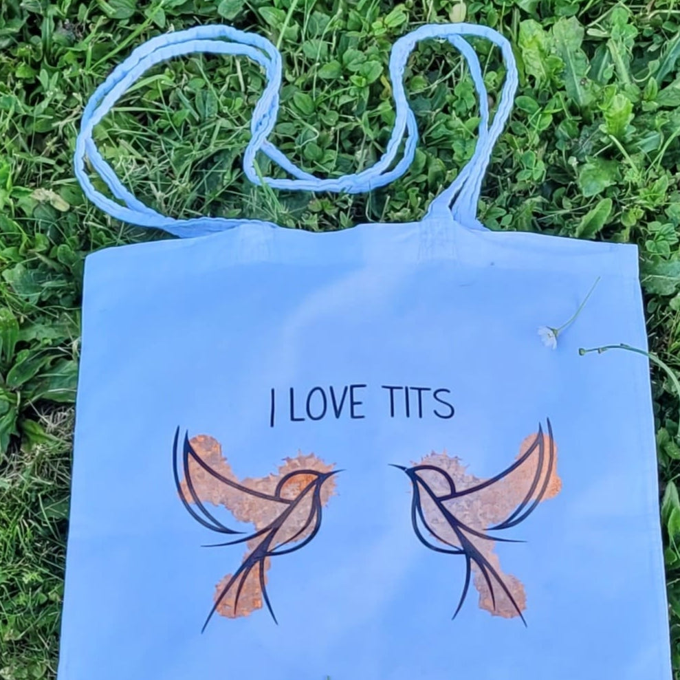Farbenfroher Stoffbeutel mit dem Schriftzug "I love Tits" von easy-sticks, der in der Natur aufgenommen wurde, ideal für kreative Unternehmungen.
