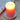 Runder Kerzenständer Silikonform von easy-sticks mit einem brennenden kerzenförmigen Element in Orange, das auf einem rustikalen Holzbrett steht, umgeben von einem bedruckten Tuch.