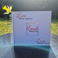 live-laugh-love Plotterdatei auf einem Buch als Beispielbild für die Anwendung