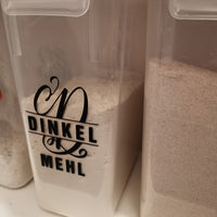 Monogramm 'D' Plotterdatei von easy-sticks - Aufbewahrungsbehälter mit einer stilvollen Beschriftung 'DINKEL MEHL' im künstlerischen Schriftzug.