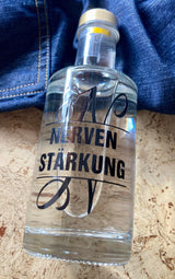 Kreatives Design einer Flasche mit dem Monogramm 'N' und dem Schriftzug 'NERVEN STÄRKUNG', ideal für DIY-Projekte mit der Monogram 'N' Plotterdatei von easy-sticks.