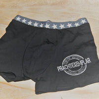 Schwarze Unterhose mit dem Aufdruck 'Prachtexemplar', unisex und kreativ gestaltet, gefertigt von easy-sticks.