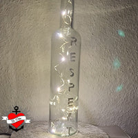 Eine dekorative Glasflasche mit Lichtern und dem Schriftzug "RESPEKT", gestaltet mit der "Respekt" Plotterdatei von easy-sticks. Eine einzigartige Ambiance für jedes Zuhause.