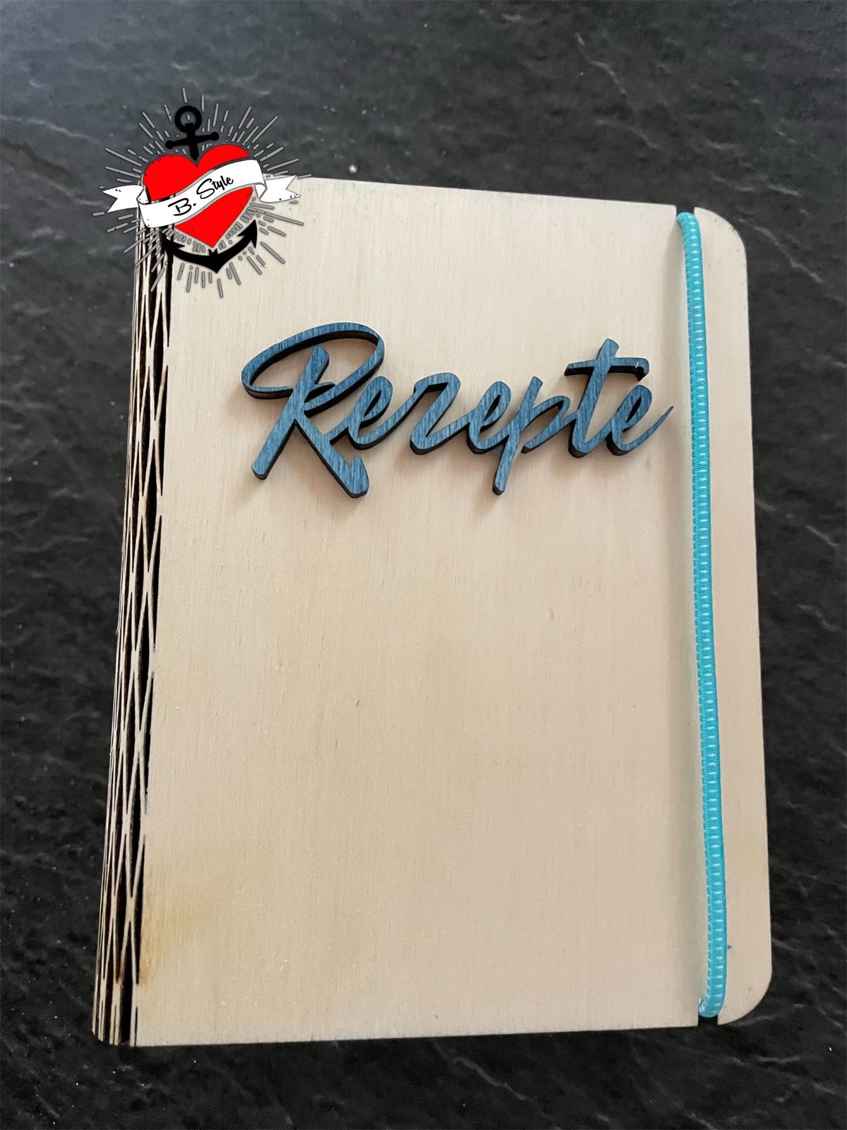 Holz-Rezeptbuch mit blauem Schriftzug, eine kreative Möglichkeit, die Laserdatei von Easy-Sticks zu verwenden.
