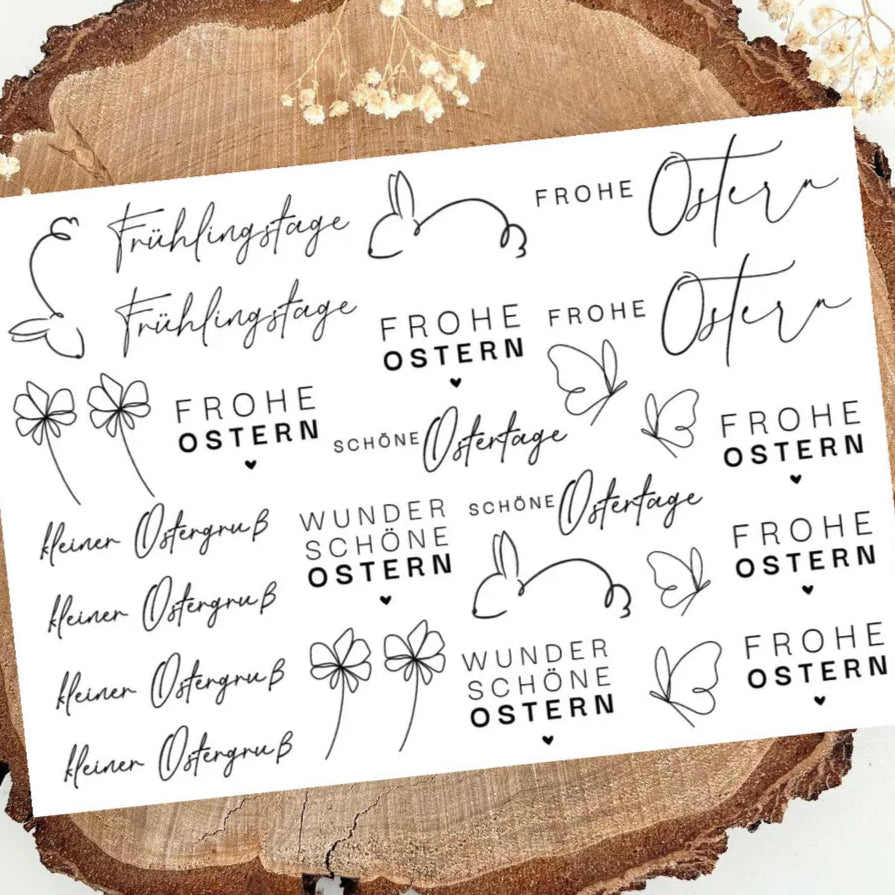 Schwarz weißes Design mit Oster-Motiven: Schriftzüge 'Frohe Ostern', Hasen und Blumen, auf einem natürlichen Untergrund. Ideal für kreative Projekte. RUB ON UV Sticker randlos von easy-sticks.