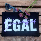 Stylisches Täschchen mit der "Schnurzpiep Egal" Plotterdatei von easy-sticks, das den Schriftzug "Schnurzpiep" in elegantem Lila und "Egal" in Weiß zeigt, auf einem Holzuntergrund.
