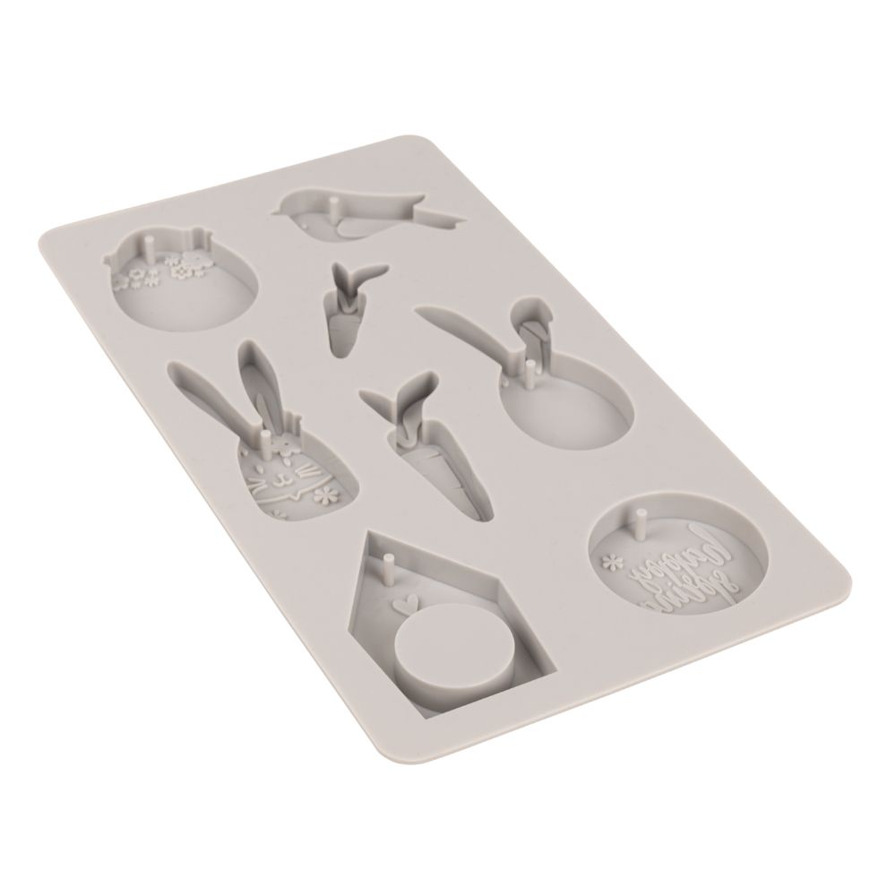 Detailansicht der Silikonform Happy Spring von Easy-Sticks, mit integrierten Zapfen für Aufhängelöcher, perfekt zum Ausgießen von Deko-Anhängern für den Frühling.
