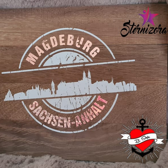 Stempel Skyline Magdeburg von easy-sticks – Die Plotterdatei präsentiert die Silhouette von Magdeburg auf einem Holzuntergrund, ergänzt durch die Aufschrift "Sachsen-Anhalt". Perfekt für kreative Bastelarbeiten.