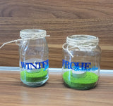 Zwei verschlossene Glasbehälter, dekoriert mit den Aufschriften 'Winter' und 'Frohe Weihnachten', gefüllt mit grüner Deko. Ein kreatives Produkt von Easy-Sticks, basierend auf der Weihnachtswörter Duo Plotter Datei.