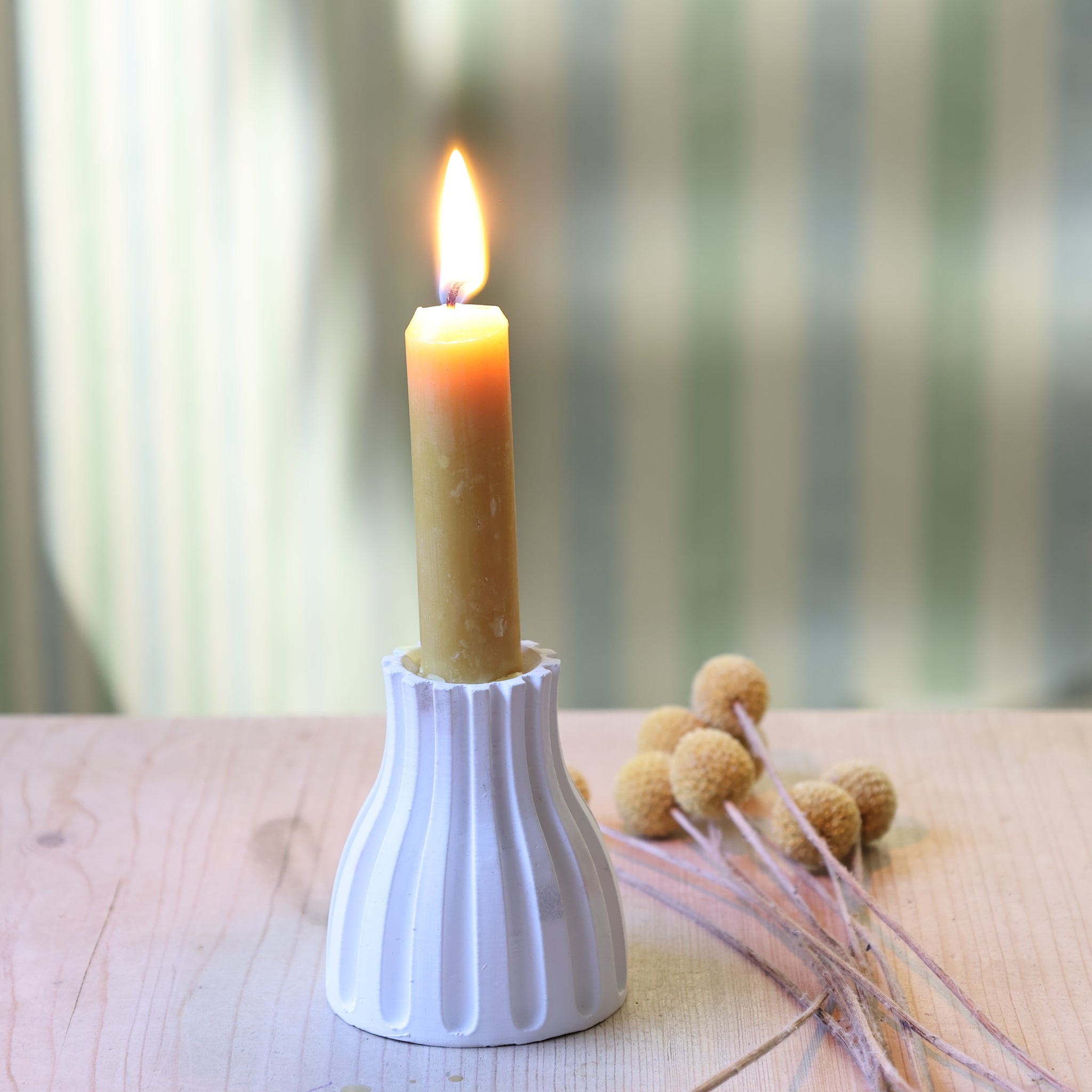 Gestreifter Kerzen-Ständer von easy-sticks mit einer brennenden, dekorativen Kerze in einem modernen Design und einer stilvollen Ambiente, perfekt für die Gestaltung von individuellen Kerzenständern.