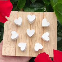 15 Mini Herzen aus Silikon von easy-sticks, auf einem Holzbrett platziert, umgeben von Blumen, um die Vielseitigkeit und Kreativität bei DIY-Projekten zu zeigen.