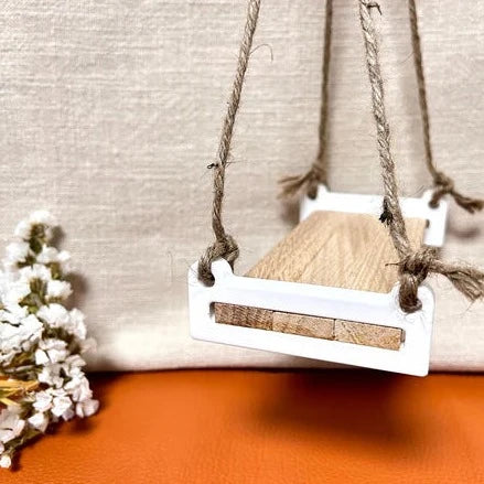 Stilvolle Schaukelbank von Easy-Sticks, aus Holz und mit weißen Akzenten, ideal für Wohnkultur und kreative Bastelideen.