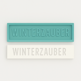 Silikonform von Easy-Sticks mit dem Schriftzug WINTERZAUBER in türkis und weiß, ideal für kreative Deko und persönliche Geschenke.