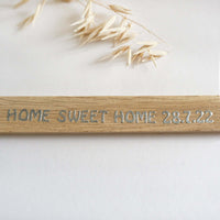 Nahaufnahme eines Holzschildes mit dem Schriftzug 'Home Sweet Home 28.7.22' von easy-sticks, ideal für Dekoration und Geschenke.